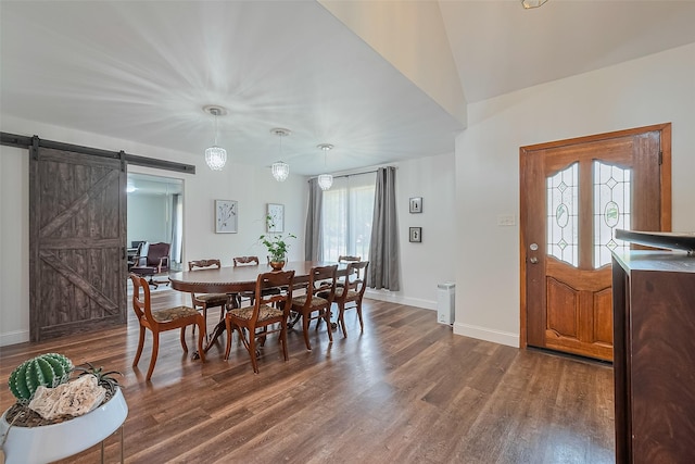 2906 Laurel Fork Dr, Houston, TX 77339 - dining space with a barn door, dark wood-style floors, and baseboards