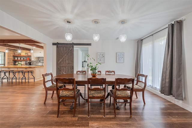 2906 Laurel Fork Dr, Houston, TX 77339 - dining space with a barn door, wood finished floors, beam ceiling, and baseboards