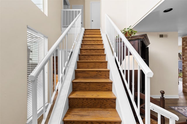 1146 Fountain View Dr Unit 204, Houston, TX 77057 - stairway featuring wood finished floors, plenty of natural light, baseboards, and a high ceiling