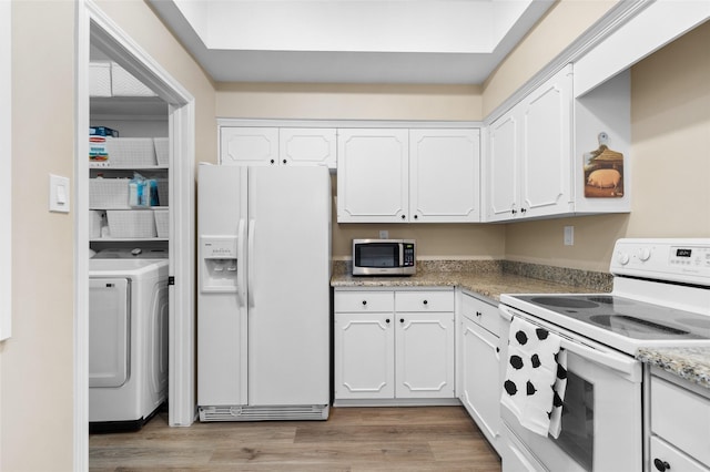 1146 Fountain View Dr Unit 204, Houston, TX 77057 - kitchen with white appliances, washer / clothes dryer, white cabinetry, and light wood finished floors