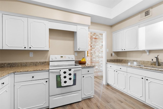 1146 Fountain View Dr Unit 204, Houston, TX 77057 - kitchen featuring white electric range, a sink, white cabinetry, light wood-style flooring, and light stone counters