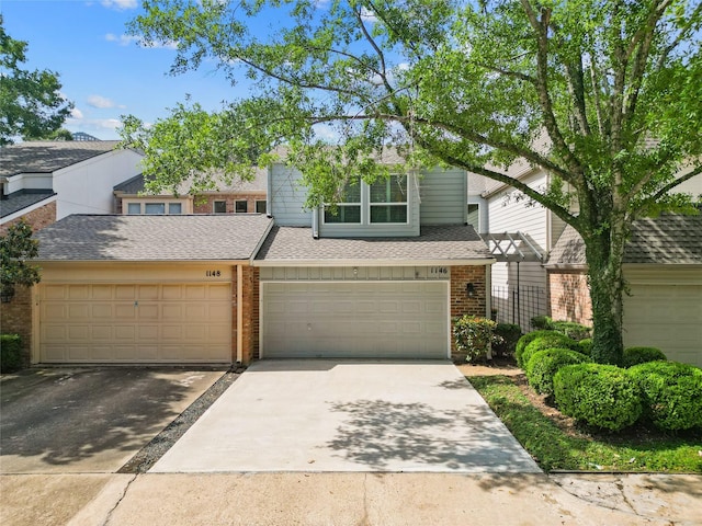 1146 Fountain View Dr Unit 204, Houston, TX 77057 - townhome / multi-family property featuring brick siding, concrete driveway, and a shingled roof