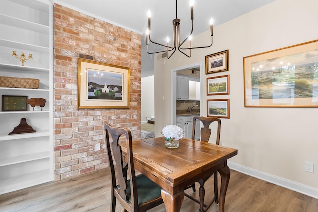 1146 Fountain View Dr Unit 204, Houston, TX 77057 - dining space with wood finished floors, a chandelier, baseboards, and built in features