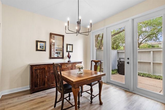 1146 Fountain View Dr Unit 204, Houston, TX 77057 - dining space with a chandelier, light wood-style floors, french doors, and baseboards