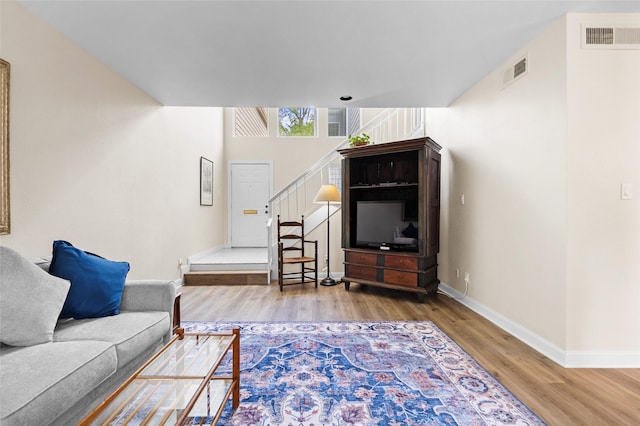 1146 Fountain View Dr Unit 204, Houston, TX 77057 - living area featuring wood finished floors, baseboards, and stairway