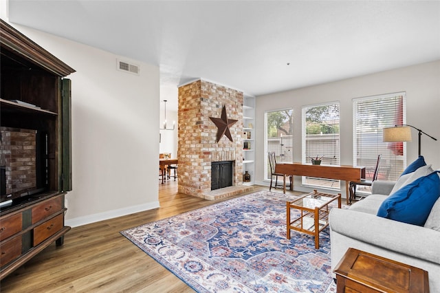 1146 Fountain View Dr Unit 204, Houston, TX 77057 - living area with wood finished floors, a brick fireplace, baseboards, and built in features