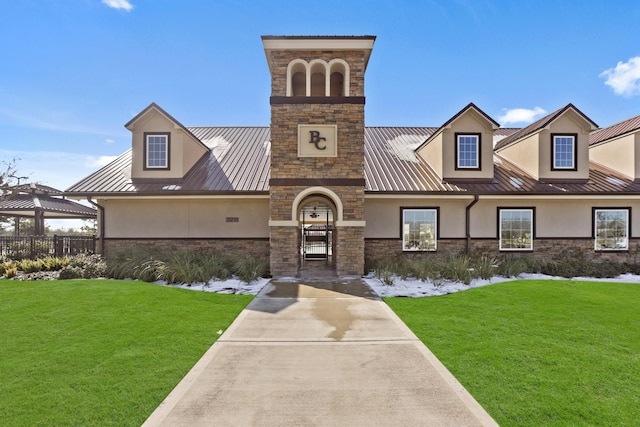 5010 Trembling Aspen Ln, Rosenberg, TX 77471 - view of front of home with stucco siding, stone siding, a standing seam roof, and metal roof