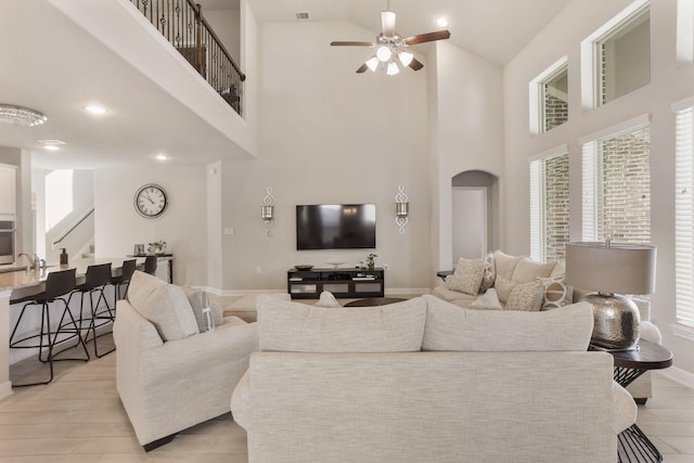 5010 Trembling Aspen Ln, Rosenberg, TX 77471 - living area featuring high vaulted ceiling, stairway, ceiling fan, baseboards, and arched walkways