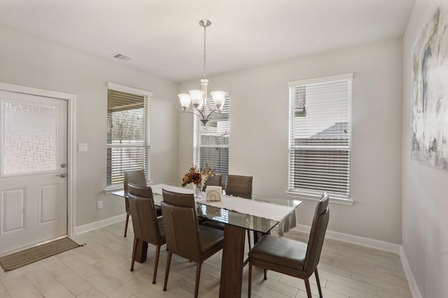 5010 Trembling Aspen Ln, Rosenberg, TX 77471 - dining space featuring a chandelier, baseboards, and light wood-style floors