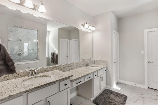 5010 Trembling Aspen Ln, Rosenberg, TX 77471 - bathroom featuring marble look tile flooring, a tile shower, baseboards, and double vanity