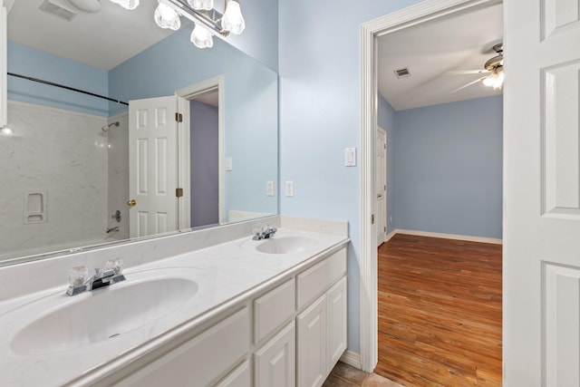 2100 Williams Glen Dr, Bryan, TX 77808 - full bathroom with a ceiling fan, double vanity, baseboards, wood finished floors, and bathing tub / shower combination