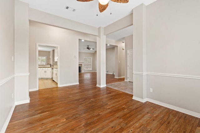 2100 Williams Glen Dr, Bryan, TX 77808 - spare room featuring ceiling fan, light wood-style flooring, a fireplace, and baseboards