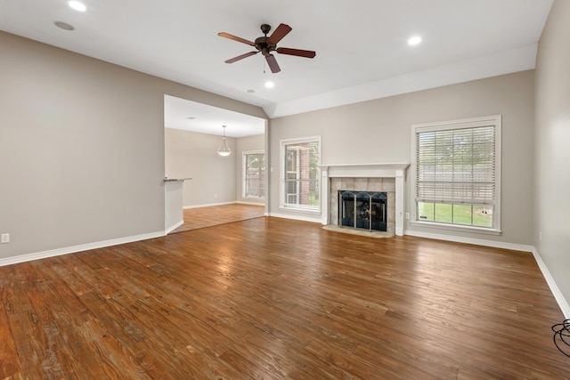 2100 Williams Glen Dr, Bryan, TX 77808 - unfurnished living room with baseboards, ceiling fan, wood finished floors, a tiled fireplace, and recessed lighting