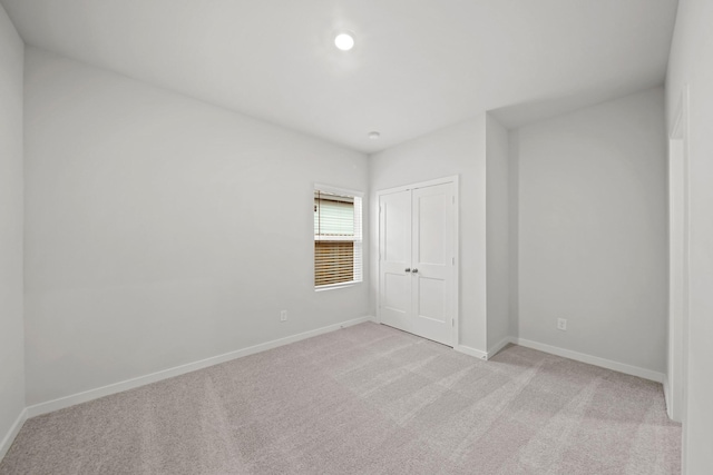 18523 Lilliput Ln, New Caney, TX 77357 - unfurnished bedroom featuring light carpet, baseboards, and a closet