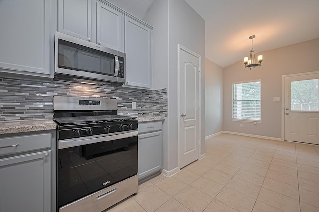 614 Starboard Ct, Katy, TX 77494 - kitchen with stainless steel appliances, backsplash, light tile patterned flooring, a chandelier, and lofted ceiling