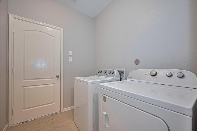 614 Starboard Ct, Katy, TX 77494 - laundry area with independent washer and dryer, light tile patterned floors, and baseboards