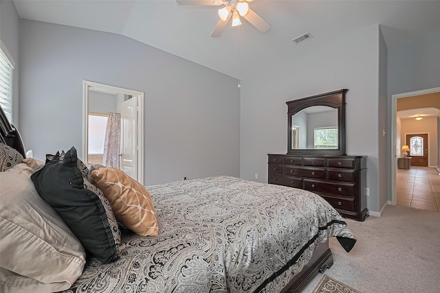614 Starboard Ct, Katy, TX 77494 - bedroom featuring multiple windows, vaulted ceiling, light colored carpet, a ceiling fan, and ensuite bath