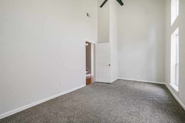 1326 Forest Home Dr, Houston, TX 77077 - spare room with a towering ceiling, carpet, baseboards, a ceiling fan, and stairs