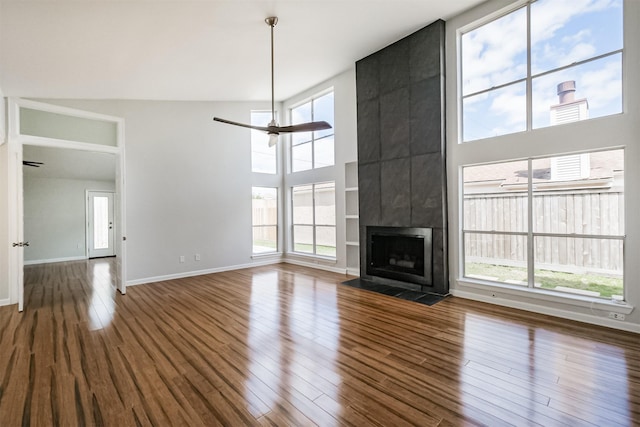 1326 Forest Home Dr, Houston, TX 77077 - unfurnished living room featuring ceiling fan, wood finished floors, baseboards, and a tile fireplace