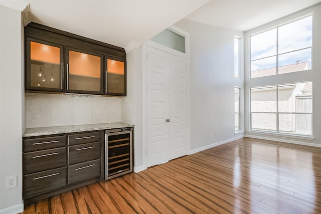 1326 Forest Home Dr, Houston, TX 77077 - bar with beverage cooler, dark wood-type flooring, and baseboards