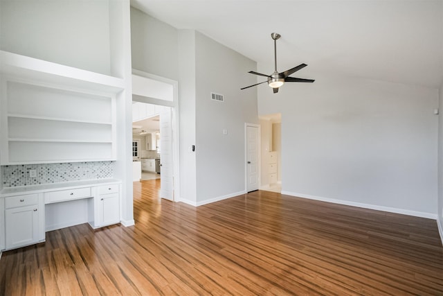 1326 Forest Home Dr, Houston, TX 77077 - unfurnished living room with ceiling fan, high vaulted ceiling, baseboards, and wood finished floors