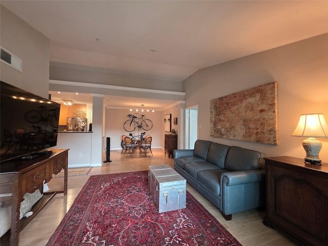 3231 Allen Pkwy Unit 4307, Houston, TX 77019 - living room with a chandelier, decorative columns, and light wood-style flooring