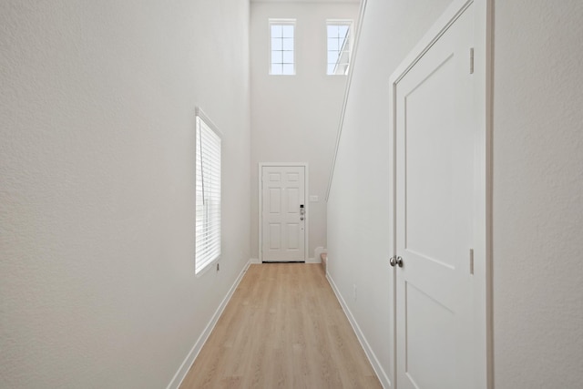 7919 Grand Louis Way, Spring, TX 77379 - hallway featuring light wood finished floors and a high ceiling