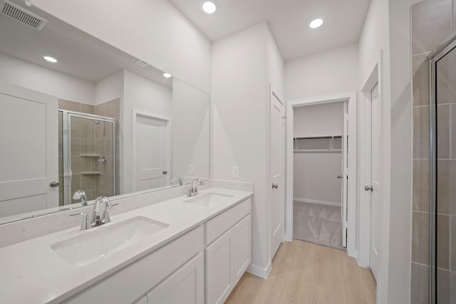 7919 Grand Louis Way, Spring, TX 77379 - full bath with a shower stall, double vanity, a spacious closet, wood finished floors, and recessed lighting