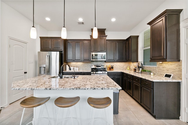 126 Biltmore Loop, Montgomery, TX 77316 - kitchen featuring stainless steel appliances, a sink, dark brown cabinetry, a kitchen island with sink, and recessed lighting