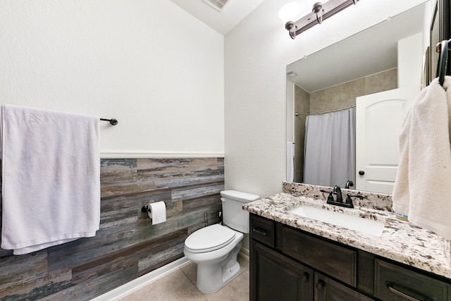 126 Biltmore Loop, Montgomery, TX 77316 - full bathroom with vanity, toilet, a shower with shower curtain, tile patterned floors, and wainscoting