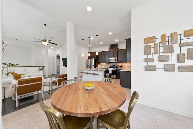 126 Biltmore Loop, Montgomery, TX 77316 - dining room featuring light tile patterned floors, arched walkways, ceiling fan, recessed lighting, and baseboards