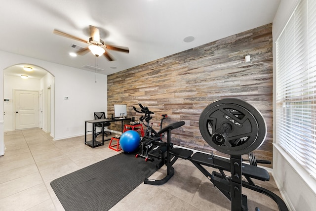 126 Biltmore Loop, Montgomery, TX 77316 - workout area featuring arched walkways, wooden walls, a ceiling fan, an accent wall, and baseboards