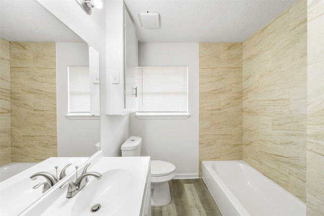 11306 Heatherwood Dr, Houston, TX 77076 - full bath with toilet, wood finished floors, vanity, and baseboards