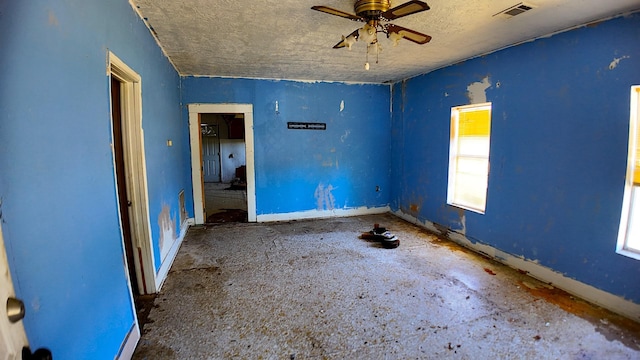 270 S 9th St, Silsbee, TX 77656 - unfurnished room featuring a textured ceiling, plenty of natural light, ceiling fan, and baseboards