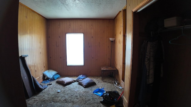 270 S 9th St, Silsbee, TX 77656 - unfurnished bedroom with a textured ceiling and wood walls