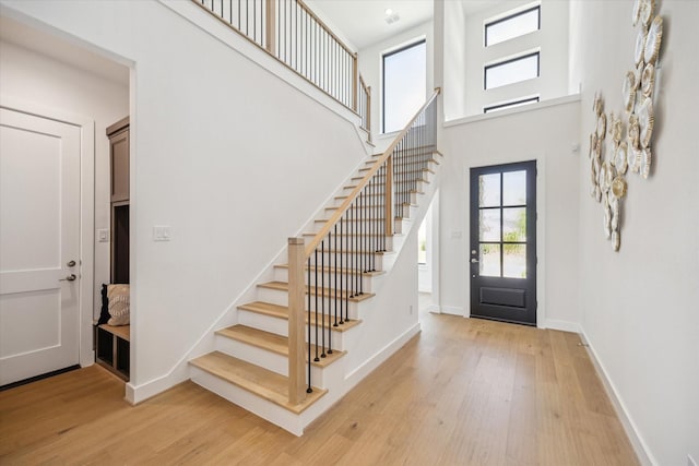 403 Venado View Ct, Conroe, TX 77304 - foyer entrance with stairs, light wood finished floors, baseboards, and a towering ceiling