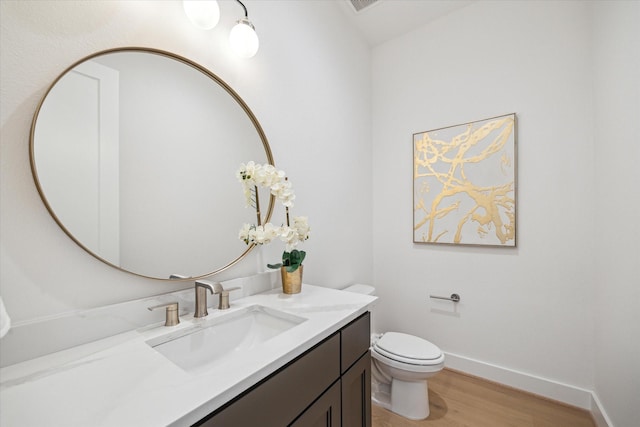 403 Venado View Ct, Conroe, TX 77304 - bathroom featuring wood finished floors, vanity, toilet, and baseboards