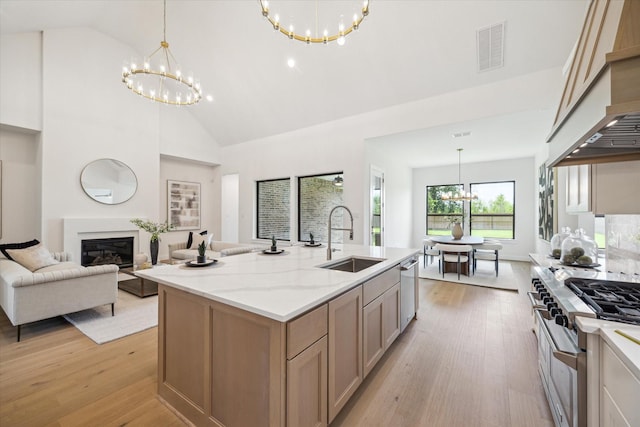 403 Venado View Ct, Conroe, TX 77304 - kitchen with a sink, a chandelier, appliances with stainless steel finishes, light wood-type flooring, and high vaulted ceiling