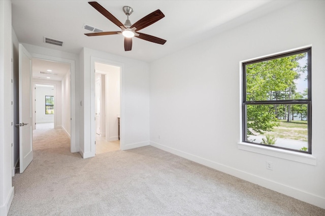 403 Venado View Ct, Conroe, TX 77304 - unfurnished bedroom featuring light colored carpet, baseboards, and a ceiling fan