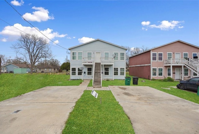 3541 Mount Pleasant St, Houston, TX 77021 - view of front of home featuring a front lawn, concrete driveway, and stairway