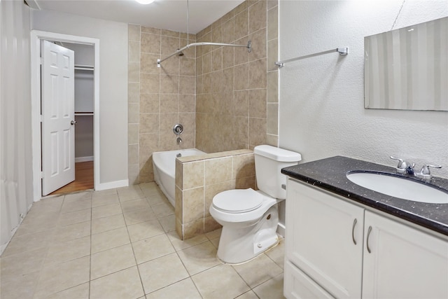 3541 Mount Pleasant St, Houston, TX 77021 - bathroom featuring tile patterned floors, toilet, vanity, washtub / shower combination, and a walk in closet