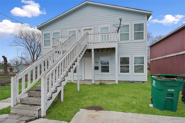 3541 Mount Pleasant St, Houston, TX 77021 - rear view of house featuring a lawn, stairway, and a wooden deck