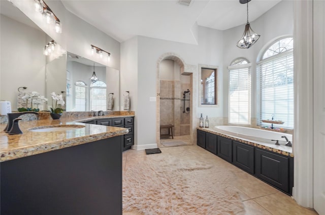 26122 Crown Ranch Blvd, Montgomery, TX 77316 - bathroom featuring healthy amount of natural light, tiled shower, a garden tub, and tile patterned floors