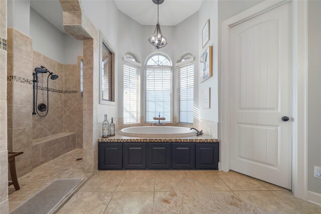 26122 Crown Ranch Blvd, Montgomery, TX 77316 - bathroom featuring a walk in shower, a garden tub, tile patterned flooring, and a chandelier