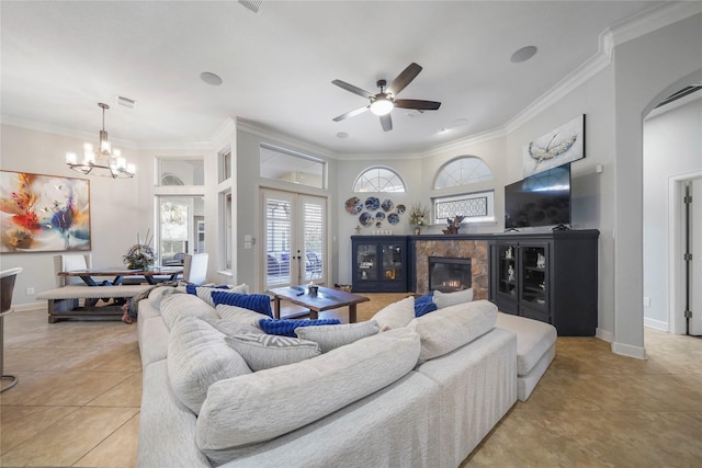26122 Crown Ranch Blvd, Montgomery, TX 77316 - tiled living room featuring crown molding, ceiling fan, a chandelier, a glass covered fireplace, and arched walkways