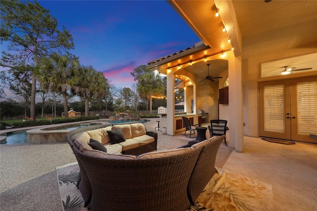 26122 Crown Ranch Blvd, Montgomery, TX 77316 - patio terrace at dusk featuring french doors, a patio area, ceiling fan, outdoor lounge area, and a pool with connected hot tub