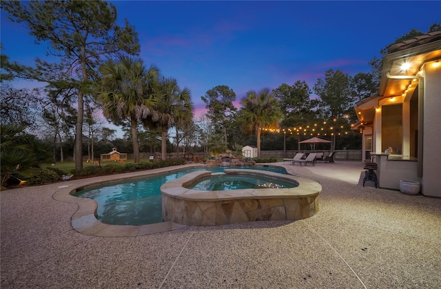 26122 Crown Ranch Blvd, Montgomery, TX 77316 - pool at dusk featuring a patio and a pool with connected hot tub