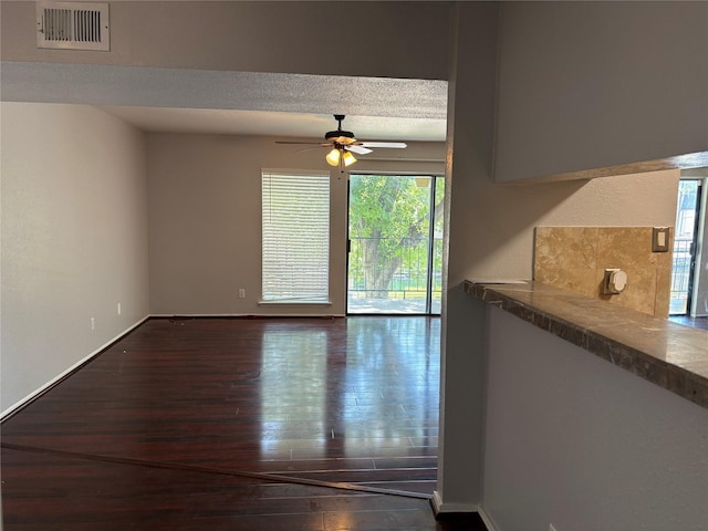 2822 S Bartell Dr Unit 22, Houston, TX 77054 - unfurnished room featuring dark wood-type flooring, a ceiling fan, baseboards, and a textured ceiling