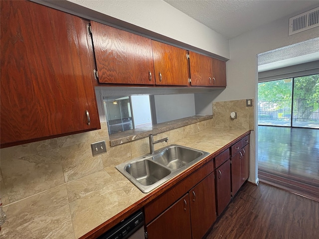 2822 S Bartell Dr Unit 22, Houston, TX 77054 - kitchen featuring a sink, decorative backsplash, light countertops, dark wood-style flooring, and a textured ceiling