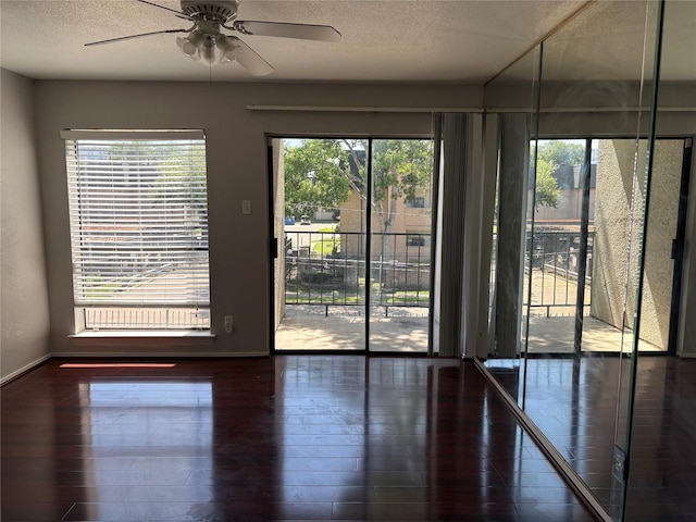 2822 S Bartell Dr Unit 22, Houston, TX 77054 - empty room with a ceiling fan, a textured ceiling, wood finished floors, and baseboards
